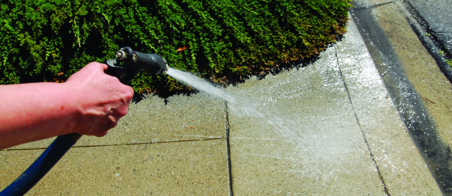 Water Restrictions Hand on Hose