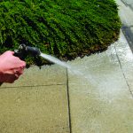 Water Restrictions Hand on Hose