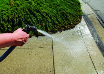 Water Restrictions Hand on Hose