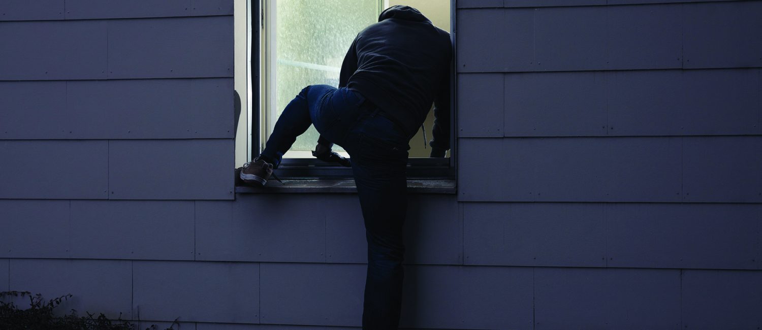 Male Criminal Climbing Thru Window