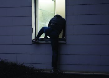 Male Criminal Climbing Thru Window