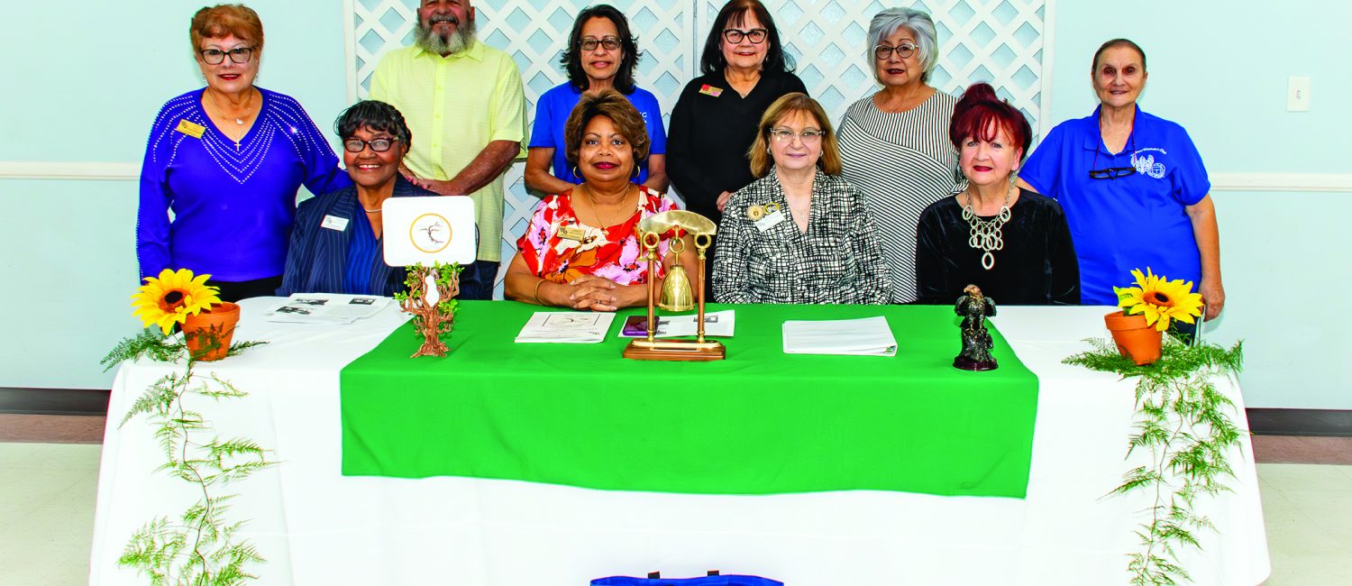 Womans Club behind desk