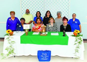 Womans Club behind desk
