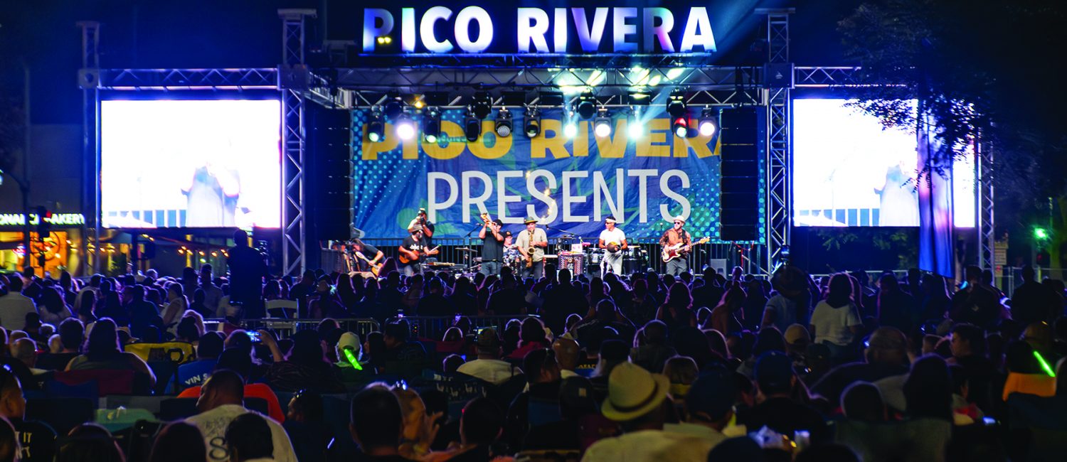 a group of people on a stage with a band playing